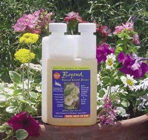 A bottle of the Beyond all natural plant booster in front of wildflowers