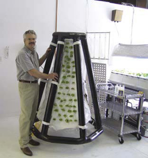 The president of Agrihouse next to an inflatable plant system